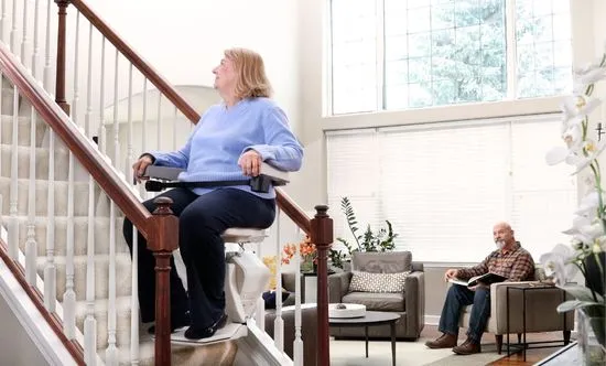 Indoor Stair Lift with female rider in a blue shirt