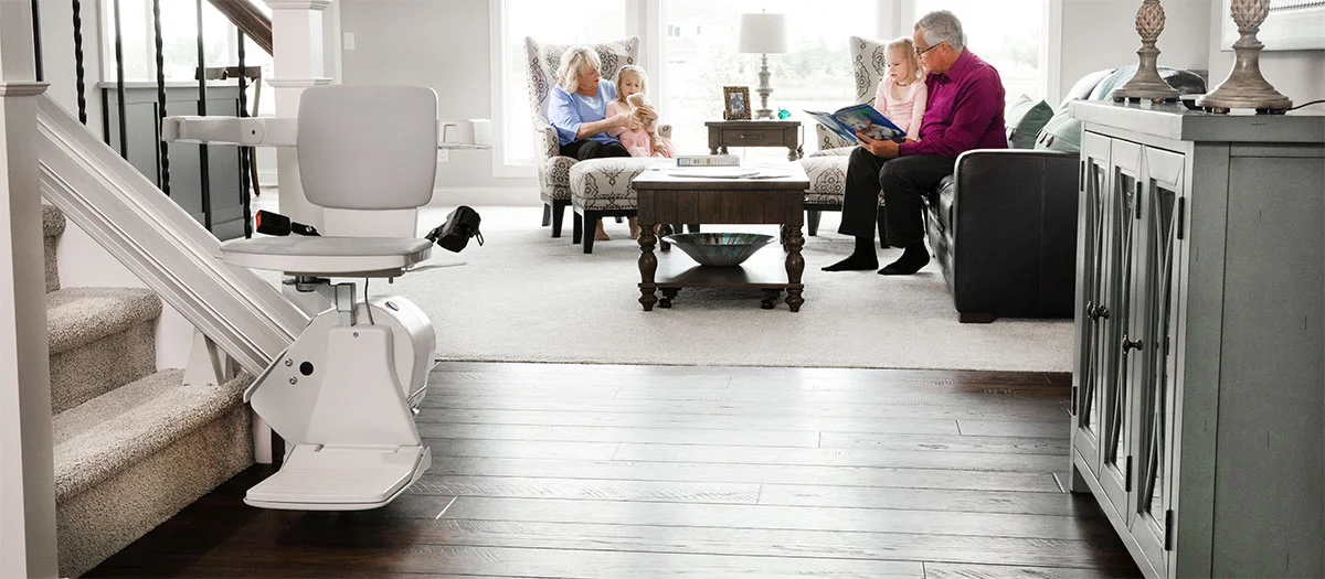 elan straight indoor stair lift with family sitting in the living room behind it