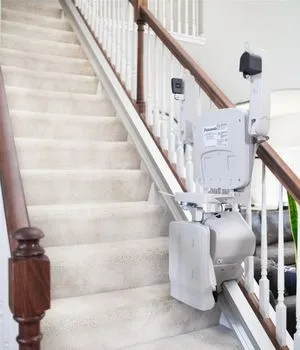 Elan straight indoor stair lift folded at the bottom of the steps