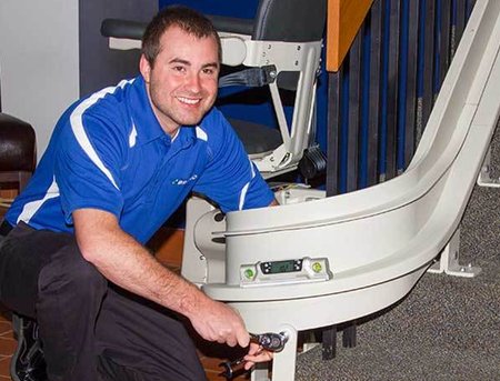 American Stairlifts service technician installing a stairlift