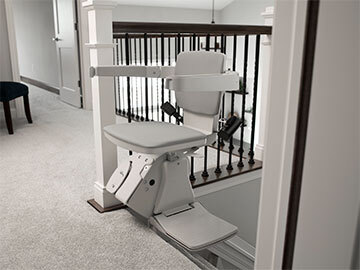 Bruno Elan straight indoor stairlift parked at the top of the steps with the seat swiveled