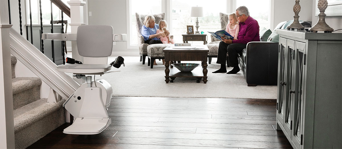 Picture of how Bruno stairlifts installed at home help people with mobility challenges enjoy all levels of their houses with family and friends