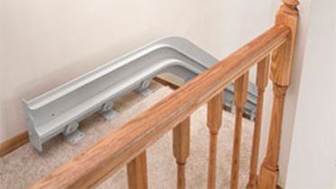 Bruno Elite Curved indoor stairlifts overrun custom option at the top of a staircase
