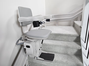 Bruno Elite Curved indoor stairlift on a custom made rail in the middle of a staircase