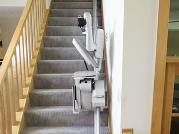 Bruno Elite straight indoor stairlift in the folded position partially up a staircase