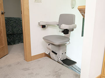 Bruno Elite straight indoor stairlift parked and rotated at the top of the steps