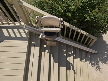 Bruno Elite straight outdoor stairlift halfway up the steps in the folded position
