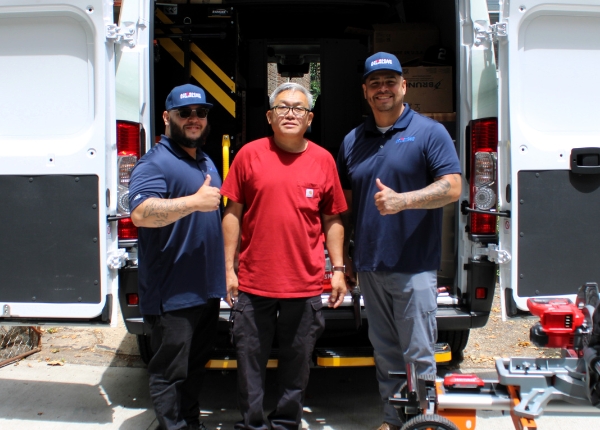 American Stairlifts service technicians standing with a customer before installation